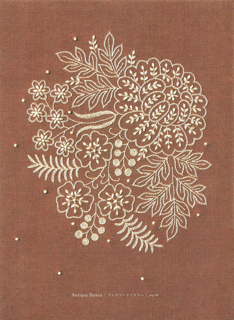 1505-09042026220514_014 Antique flower embroidery motif by Yumiko Higuchi, cream blooms and French knots on rust linen.