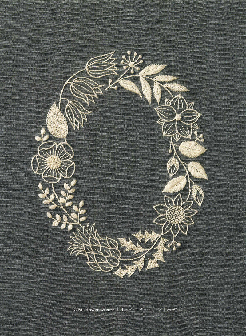 1505-09042026220514_016 Oval flower wreath embroidery design from Yumiko Higuchi, pale thread on deep charcoal linen.