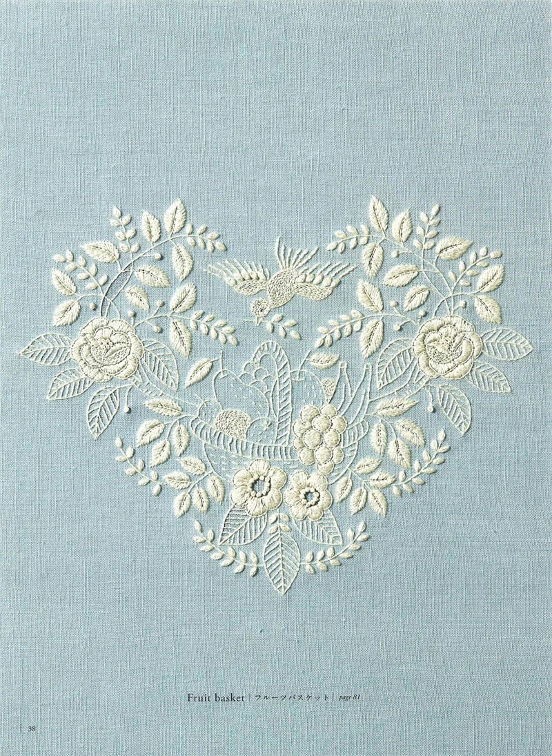 1505-09042026220514_040 Heart shaped floral embroidery motif from Yumiko Higuchi, ivory thread on soft blue linen.