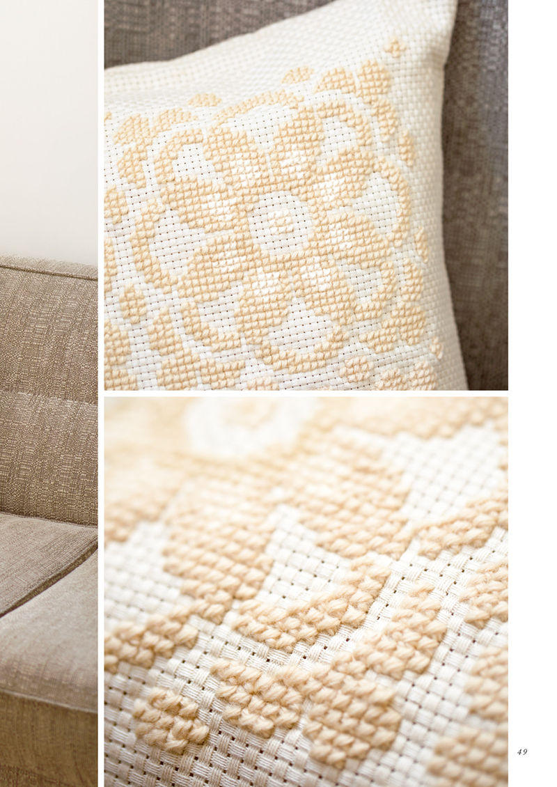 1488-00051 Close-up of cream lace stitches on a cushion, showing the dense texture of lacy cross stitch