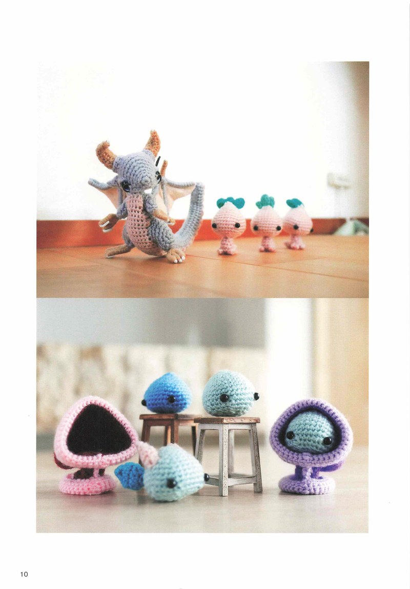 1495-04232026184535_013 Gray crochet dragon beside sprout creatures and blue monsters on a tiny stool