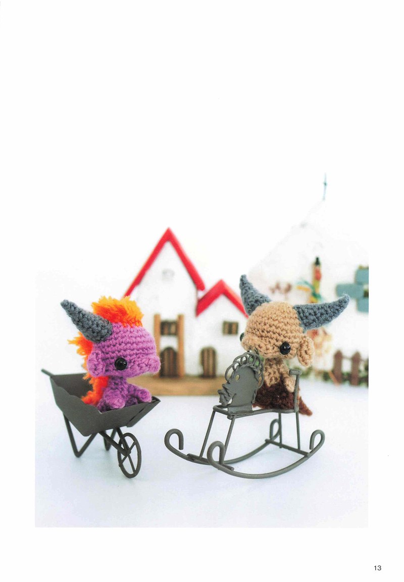1495-04232026184535_016 Purple crochet dragon pulling a tiny cart in front of a miniature house, a crochet dragon pattern scene