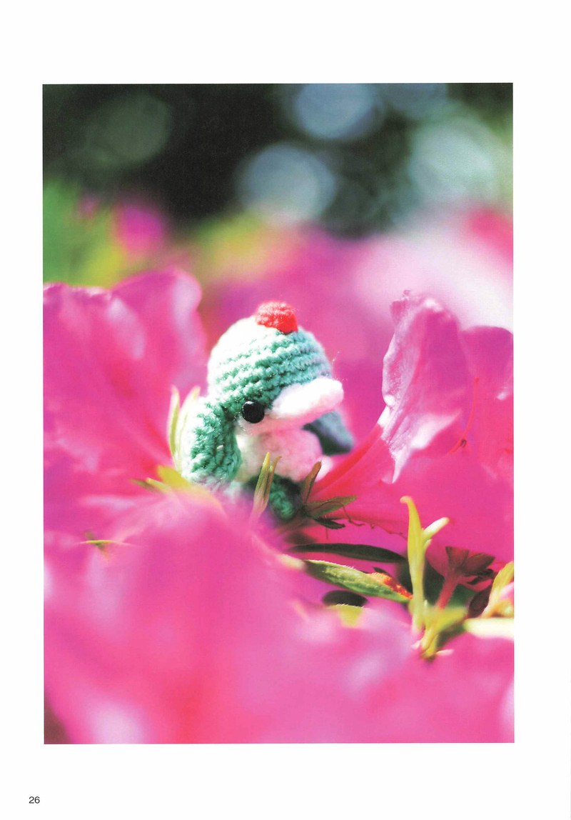1495-04232026184535_029 Green and pink crochet bird creature peeking from a bright pink blossom