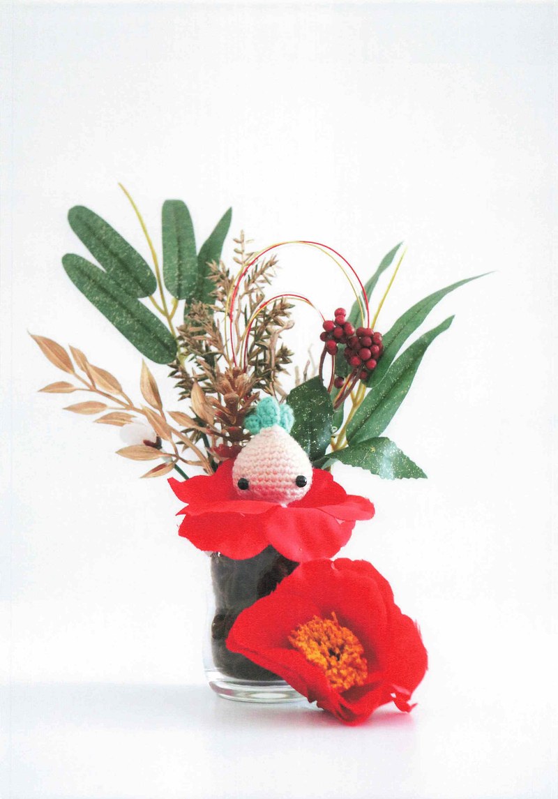 1495-04232026184535_035 Small sprout creature among red camellias in a flower arrangement