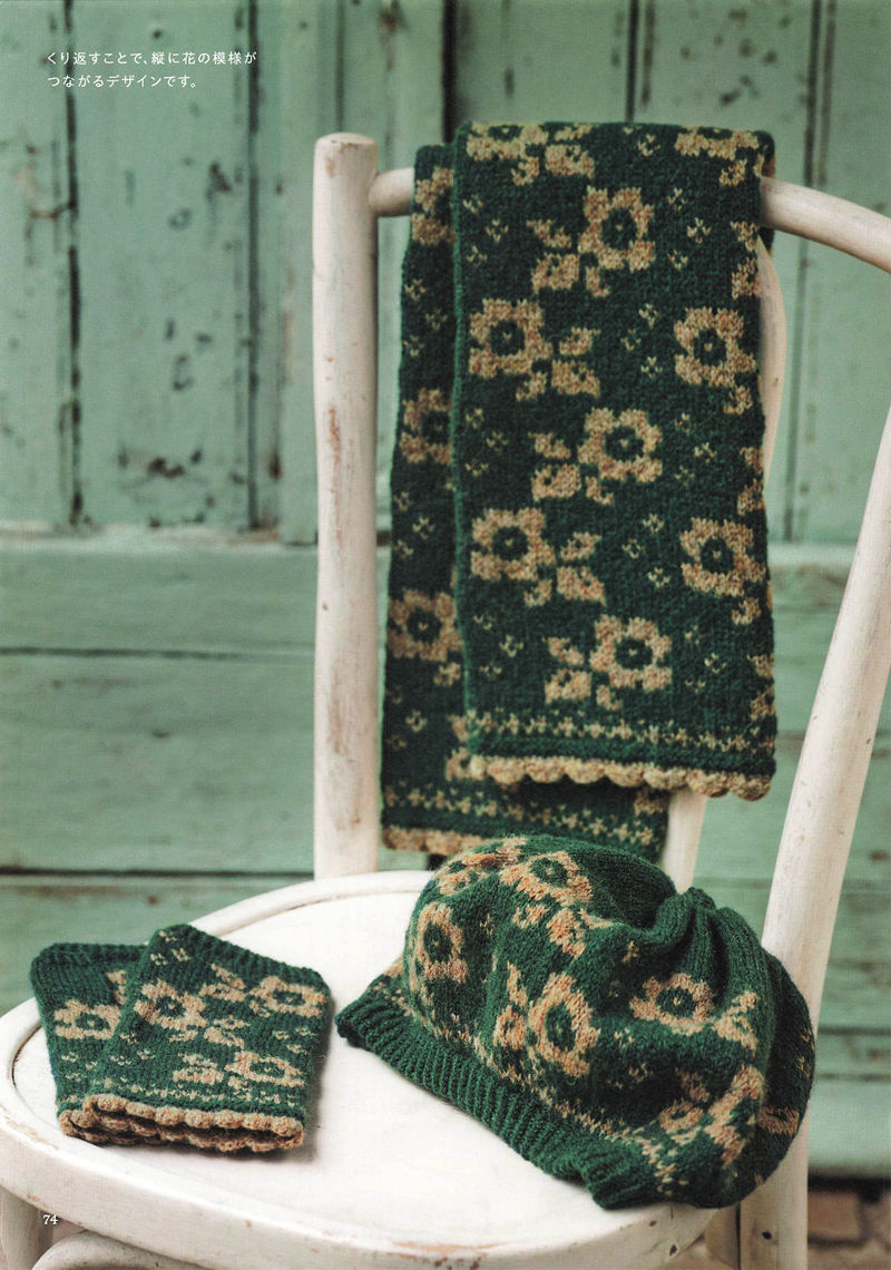 1496-20260309135601_075 Forest green and sand floral knitted scarf, mitts and cowl styled on a white chair as a matching winter set