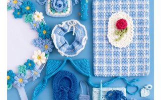 Cover of a Japanese crochet oshi goods book by Mochida Akari with blue pouches, a flower wreath and a gingham tablet case
