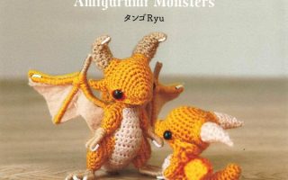 Amigurumi monsters crochet patterns cover with two small orange crochet dragons on a wooden table